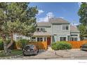 Well-maintained exterior of townhome with a charming front fence and a vibrant red front door at 5150 Buckingham Rd, Boulder, CO 80301