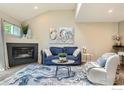 Cozy living room featuring a fireplace, modern decor and stylish blue-themed accent rug and furniture at 5150 Buckingham Rd, Boulder, CO 80301