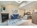 Bright living room featuring vaulted ceilings, fireplace, wood floors, and open floor concept at 5150 Buckingham Rd, Boulder, CO 80301