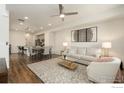 Bright living room featuring modern decor and an open concept design with hardwood floors at 5341 Warrior St, Frederick, CO 80504