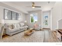 Inviting living room featuring neutral decor, a plush sofa, and stylish accents with an outdoor view at 5341 Warrior St, Frederick, CO 80504