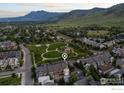 Scenic aerial view of the property, neighborhood park, and stunning mountain backdrop at 555 Laramie Blvd, Boulder, CO 80304