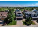 Overhead view of a residential neighborhood showcasing homes with well-maintained yards, mature trees, and mountain views at 5609 Mount Sanitas Ave, Longmont, CO 80503