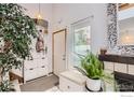 Bright entryway with tiled floors, a decorative mirror, a house plant, and convenient storage at 780 Walnut St # A, Boulder, CO 80302