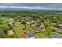 Expansive aerial view showcases the home's setting within a lush, green landscape and distant mountain views at 8840 Niwot Rd, Niwot, CO 80503