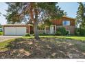 Charming two-story brick home featuring a well-manicured front yard and an attached two-car garage at 8840 Niwot Rd, Niwot, CO 80503