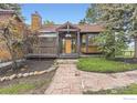 Inviting home entrance with wooden porch and beautiful tiled roof at 916 W Alder St, Louisville, CO 80027