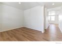 Bright, open bedroom with wood-look floors and fresh white walls, perfect for personalization at 955 Tallus St, Lochbuie, CO 80603