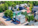An aerial view of a modern neighborhood with colorful homes, lush greenery, and interesting architecture at 1028 Katy Ln, Longmont, CO 80504