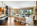 Open-concept living room with hardwood floors, large windows, and seamless indoor-outdoor flow at 1107 Juniper Ave, Boulder, CO 80304