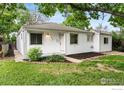 Charming single-story home features a manicured lawn, complemented by fresh paint and updated landscaping at 1111 Wabash St, Denver, CO 80220