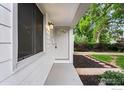 Close-up of the front porch, showcasing the freshly painted door and modern lighting fixture at 1111 Wabash St, Denver, CO 80220