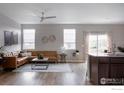 Bright, open living area featuring hardwood floors, modern furniture, and ample natural light at 14605 Longhorn Dr, Mead, CO 80542