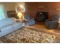 Inviting living room with a brick fireplace, comfortable seating, and a stylish area rug at 14751 E 24Th Ave, Aurora, CO 80011
