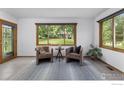Cozy sitting room with comfortable chairs, natural light, and a view of the backyard at 1922 15Th Ave, Longmont, CO 80501