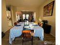Elegant dining room with hardwood floors and a long table perfect for entertaining at 1931 Rannoch Dr, Longmont, CO 80504
