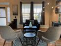 Cozy living room featuring hardwood floors, modern decor, and plenty of natural light at 1931 Rannoch Dr, Longmont, CO 80504