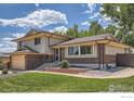 Attractive home showcasing brick and siding, lush lawn, and landscaped garden beds at 1951 S Deframe Way, Lakewood, CO 80228