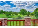 A stunning view of the golf course and snow-capped mountains from the backyard at 2226 Eagles Nest Dr, Lafayette, CO 80026