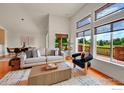 Inviting living room with large windows, stylish furniture and access to outdoor views at 2226 Eagles Nest Dr, Lafayette, CO 80026