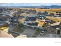 Aerial view of a residential area showcasing many single-Gathering homes and mountain views at 2483 Tabor St, Berthoud, CO 80513