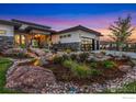 Lush landscaping with decorative stone and rock features enhances the front of the property at 2659 Heron Lakes Pkwy, Berthoud, CO 80513