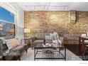 Elegant living room showcases exposed brick wall, comfortable seating, and stylish decor at 3321 Navajo St, Denver, CO 80211