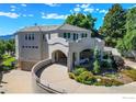 Elegant home featuring stucco, covered parking, and professional landscaping at 3747 Mountain Laurel Pl, Boulder, CO 80304
