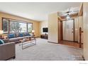 Bright living room featuring large bay window, neutral walls, and plush carpet at 4720 S Grant St, Englewood, CO 80113