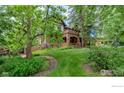 View of charming two-story home with mature landscaping and stone walkway at 604 Mapleton Ave, Boulder, CO 80304