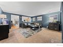 Cozy living room with plush carpet, comfortable sectional, and stylish decor at 858 Turpin Way, Erie, CO 80516