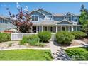 Attractive home with a well-manicured lawn, walkway, and flowering shrubs at 9273 W 107Th Pl, Broomfield, CO 80021