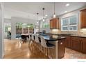 A kitchen featuring an island with barstool seating, wooden cabinets, and views of the outside patio at 1043 Terrace S Cir, Boulder, CO 80304