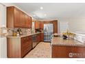 Spacious kitchen features stainless steel appliances, granite countertops, and ample cabinet space, perfect for culinary enthusiasts at 10844 W 68Th Ave, Arvada, CO 80004