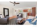 Open-concept living space with hardwood floors flows seamlessly into the kitchen, perfect for entertaining and modern living at 10844 W 68Th Ave, Arvada, CO 80004