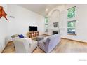 Inviting living room featuring vaulted ceilings, a cozy fireplace, and lots of natural light at 13673 Cook St, Thornton, CO 80602