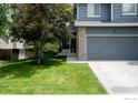 Charming home with a well-manicured lawn, mature trees, and a two-car garage at 13836 Harrison Dr, Thornton, CO 80602
