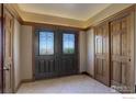 Welcoming front entry with tile floors, glass paneled doors and wood trim at 14448 Hanover St, Brighton, CO 80602