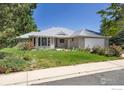 Beautiful single-story home with a well-manicured lawn, mature landscaping, and attached two-car garage at 1448 16Th Ave, Longmont, CO 80501