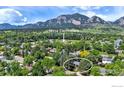 Beautiful aerial view of the property surrounded by lush trees, near Mesa Elementary and scenic mountains at 1505 Kendall Dr, Boulder, CO 80305