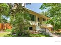 Charming split-level home with a well-maintained lawn and mature trees enhancing its curb appeal at 1505 Kendall Dr, Boulder, CO 80305