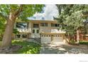Charming home featuring lush lawn, mature trees, an attached garage and a cozy front entrance at 1505 Kendall Dr, Boulder, CO 80305