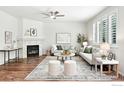 Bright living room with fireplace, ceiling fan, and plush furnishings at 1662 Crestview Ln, Erie, CO 80516