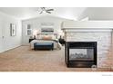Inviting primary bedroom boasting a fireplace, plush carpet, and a serene ambiance at 1662 Crestview Ln, Erie, CO 80516