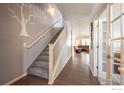 Hallway view of open floorplan with staircase and doorway to living area at 190 Olympia Ave, Longmont, CO 80504
