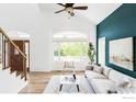 Inviting living room with lots of natural light, a vaulted ceiling and a large window at 2073 Eisenhower Dr, Louisville, CO 80027