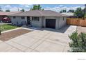 Charming exterior showcases the brick house and the driveway that leads to the one car garage at 235 N 12Th Ave, Brighton, CO 80601