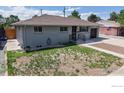 An eye-level shot of the exterior reveals the home and the front yard at 235 N 12Th Ave, Brighton, CO 80601