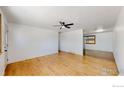 Bright living room features hardwood floors and a ceiling fan at 235 N 12Th Ave, Brighton, CO 80601