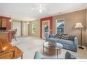 Bright living room with a comfortable sofa, large windows, and an adjacent kitchenette at 237 Cardinal Way # 202, Longmont, CO 80501